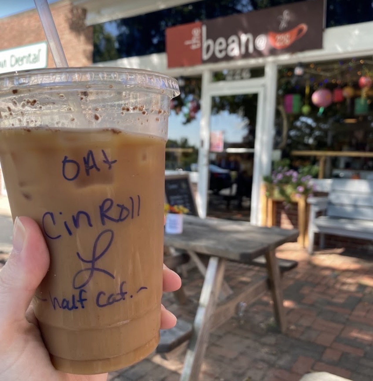 Oat Cin Roll iced latte in front of The Bean @226 storefront